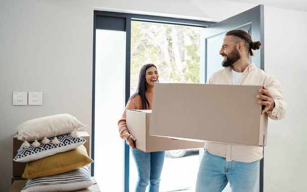 Couple moving, new house and box with happiness, man and woman, real estate property and home owner. People carrying boxes, laughing together and partnership, happy with mortgage and funny relocation. - Foto, immagini