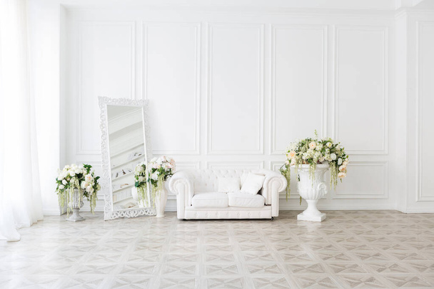 Luxury white interior of living spacious room with elegant chic furniture and high windows. - 写真・画像
