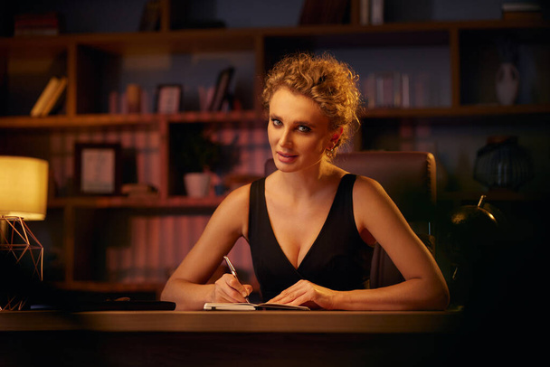 Purposeful young business woman, professional entrepreneur, reads a book. Business woman in a beautiful office in cinematic light. A beautiful portrait - Фото, изображение