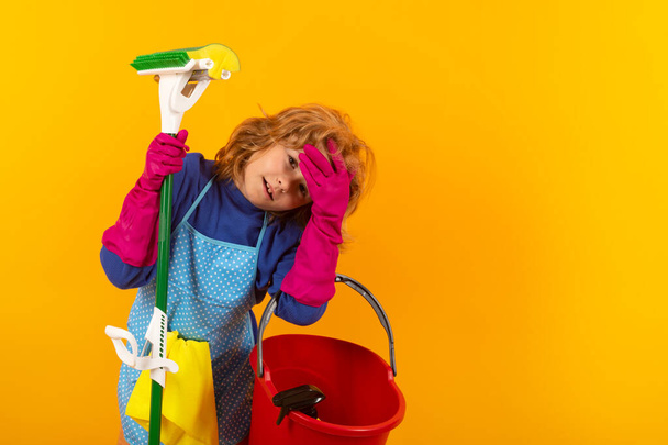 Portrait of child cleaning, concept growth, development, family relationships. Housekeeping and home cleaning concept. Child use duster and gloves for cleaning. Studio isolated background - Fotografie, Obrázek