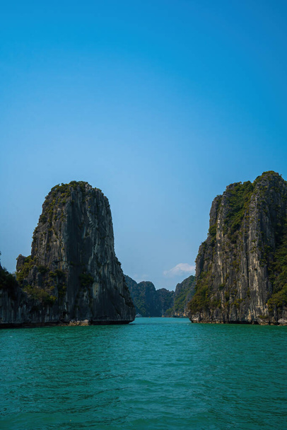 Scenic view of rock island in HaLong Bay, Vietnam, Southeast Asia. UNESCO World Heritage Site. Mountain islands at Ha Long Bay. Beautiful landscape Popular asian landmark famous destination of Vietnam - Photo, Image