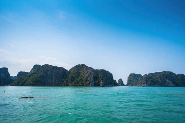 Scenic view of rock island in HaLong Bay, Vietnam, Southeast Asia. UNESCO World Heritage Site. Mountain islands at Ha Long Bay. Beautiful landscape Popular asian landmark famous destination of Vietnam - Fotoğraf, Görsel
