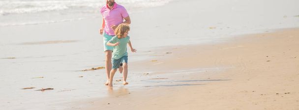 cropped father and son running on summer beach. family travel weekend and vacation. fathers or family day. daddy with kid boy on summer day. dad and child having fun outdoors. copy space. - 写真・画像