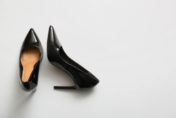 Pari mustia korkeakorkoisia kenkiä kevyellä taustalla - Valokuva, kuva
