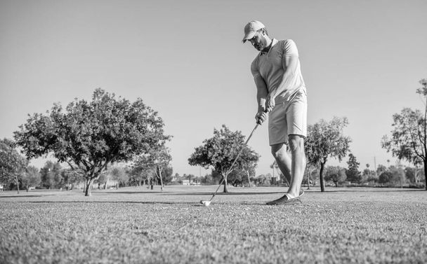 summer activity. professional sport outdoor. male golf player on professional golf course. portrait of golfer in cap with golf club. people lifestyle. sporty man playing game on green grass. - Foto, afbeelding
