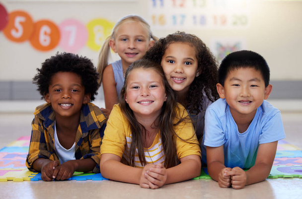 Education, portrait or happy children in classroom learning or smiling in preschool together with support. Kids development, diversity or students with growth mindset for knowledge in kindergarten. - Photo, Image