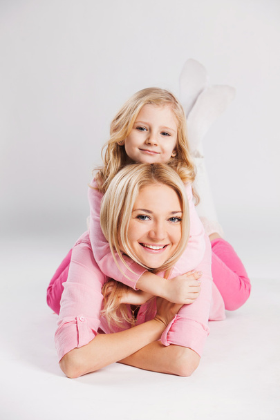 Closeup portrait of happy mother and little smiling daughter - isolated. Happy family people concept. - Фото, изображение