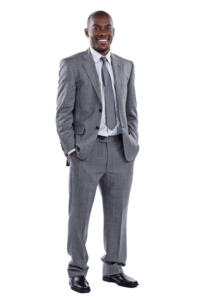 Me and business are a perfect fit. Full length portrait of a businessman standing with his hands in his pockets against a white background - Фото, изображение