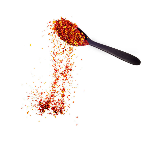 powder paprika with wooden spoon flying scoop isolated on white background. - Foto, imagen