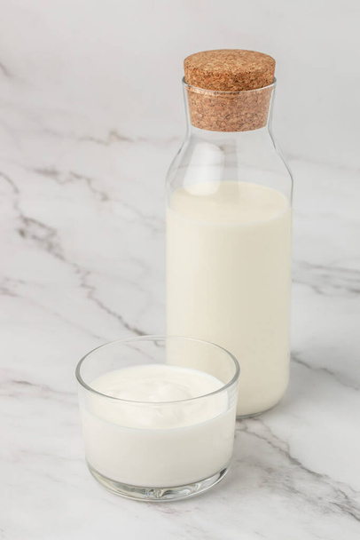 A bottle of milk and glass of yogurt, kefir, fermented milk, Probiotic cold fermented dairy drink. top view, - 写真・画像