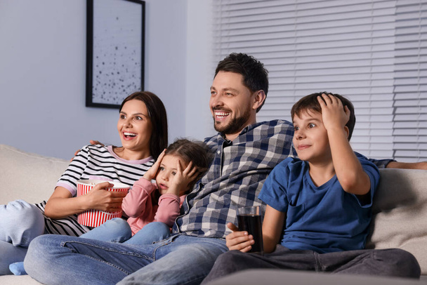 Family watching TV at home in evening - Φωτογραφία, εικόνα
