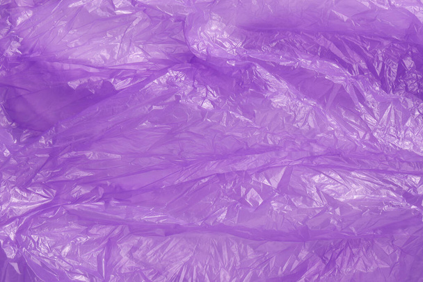 Crumpled purple plastic bag as background, top view - Foto, immagini