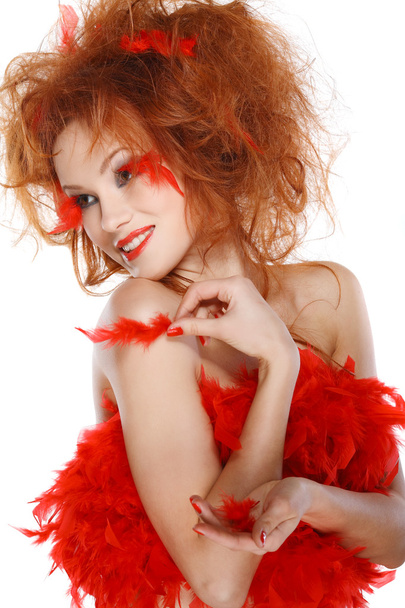 Beautiful redheaded girl with red feathers - Zdjęcie, obraz