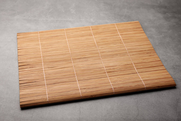 New clean bamboo mat on grey table - Fotoğraf, Görsel