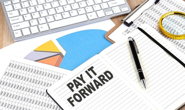 PAY IT FORWARD text on paper on chart background - Photo, Image