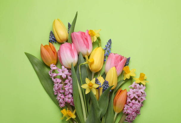 Beautiful bouquet of different flowers on green background, flat lay. Space for text - Photo, Image