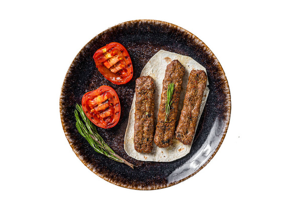 Grilled Urfa shish kebab on a plate with tomato. Isolated on white background - Foto, Imagem