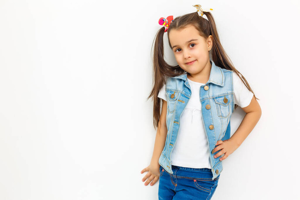 Full body size length of girlish nice cute cheerful adorable lovely stylish small little girl with curly pigtails in formal blouse shirt, short blue skirt, thinking. Isolated over background - 写真・画像
