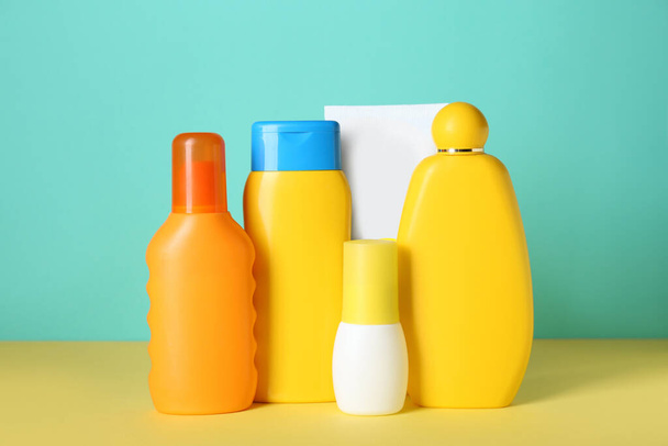 Many different suntan products on color background - Foto, Imagem