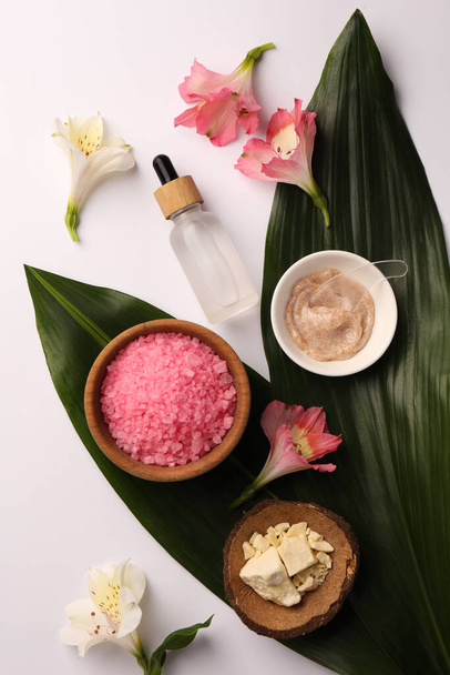 Flat lay composition with different spa products and beautiful flowers on white table - Foto, Imagem