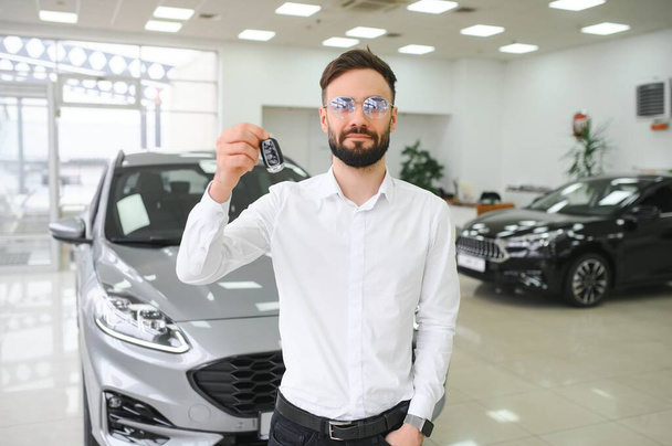 Man confident customer male buyer client wear white shirt choose auto want buy new automobile in showroom vehicle dealership store motor show indoor Sales concept - Фото, зображення