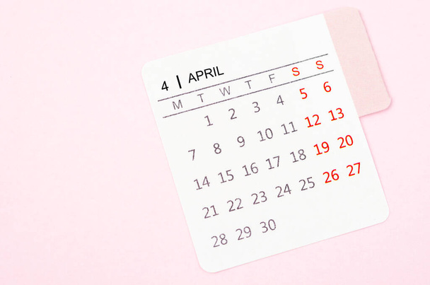 Mini April calendar on a pink color background. High resolution and copy space for all your text or message. - Photo, image
