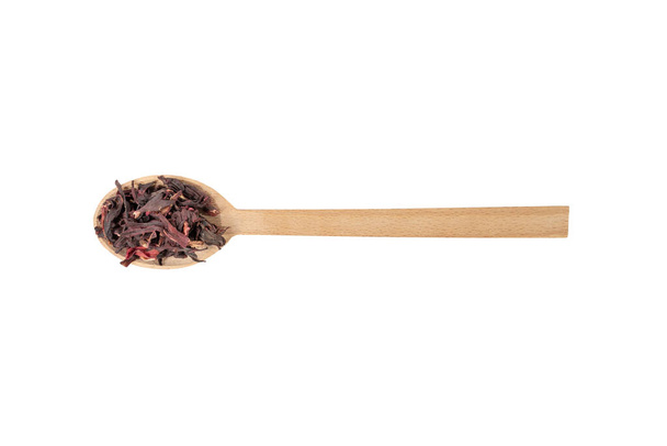 Dry hibiscus tea on wooden spoon isolated on white background. herb. herbal tea. food ingredient. - Fotó, kép