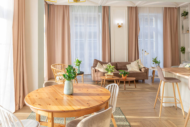 modern expensive luxurious open-plan apartment. Rich Scandinavian-style interior with wooden beams on the ceiling in pastel colors - Zdjęcie, obraz