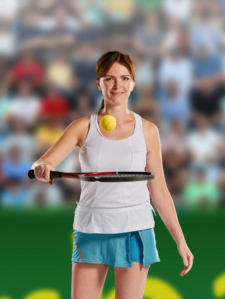 Portrait of young beautiful female tennis player on professional tennis court - Фото, изображение
