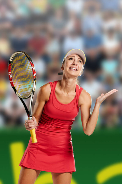 Emotional fit young woman playing tennis on professional court with spectators - Foto, Bild