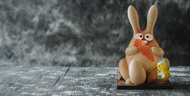 a white chocolate easter bunny as a spanish mona de pascua, a traditional confection given by godparents to godchild on easter, in a panoramic format to use as web banner - Foto, Bild