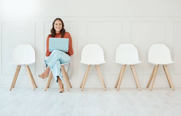 Portrait, laptop and woman in waiting room, interview or recruitment, hiring or office job. Computer, hr and happiness of business person or Asian female from Japan sitting on chair for employment - Zdjęcie, obraz