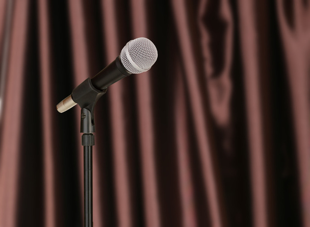 Microphone on brown curtain background - Foto, imagen