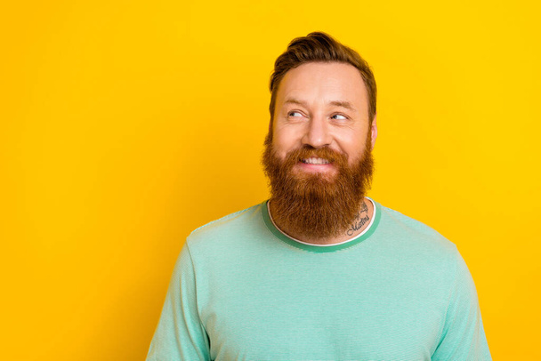 Portrait of positive cheerful man wear green mint clothes interesting promo offer empty space isolated on yellow color background. - Фото, зображення