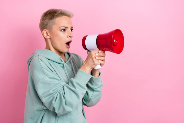 Photo portrait of lovely young lady hold loudspeaker scared shocked activist dressed stylish khaki outfit isolated on pink color background. - Foto, imagen