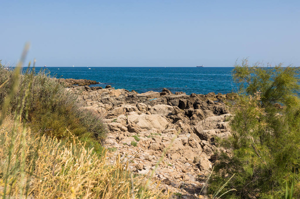 Oil tanker on the horizon from the Crique de l'Anau in Sete - Photo, Image