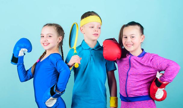 Great progress. Happy children in boxing gloves with tennis racket and ball. Fitness energy health. punching knockout. Team sport success. workout of small girls boxer and boy in sportswear. - Valokuva, kuva