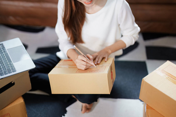 Starting small business entrepreneur of independent Asian female online seller packing products to send to customers and SME delivery concept. - Foto, Imagem