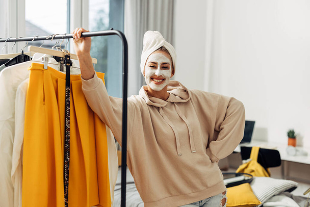 A smiling young woman with a face mask looks at the camera. Getting ready - Φωτογραφία, εικόνα