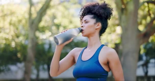 Fitness, woman and drinking water after running exercise, cardio workout or training in outdoor park. Thirsty, fit and active female runner enjoying natural drink, refreshment or hydration in nature. - Footage, Video