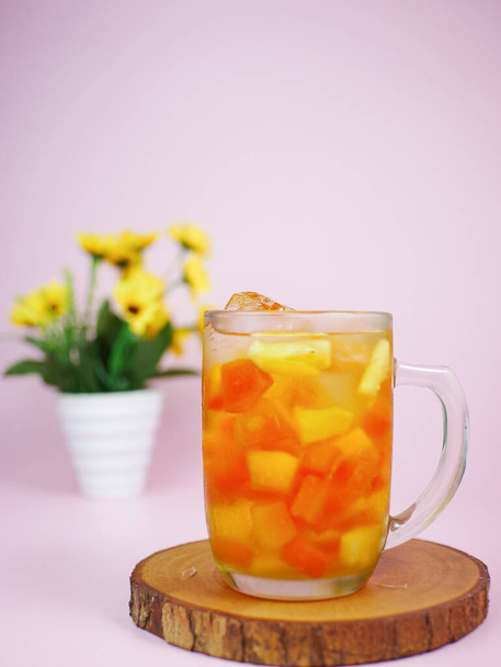 bul bul ice or fruit ice drinks filled with pieces of pineapple and papaya. Indonesian fruit ice - Foto, Imagen