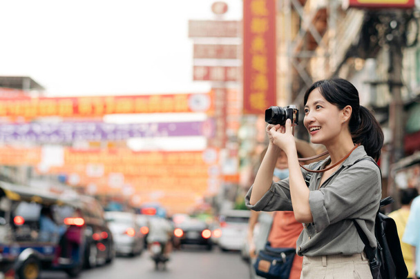 Young Asian woman backpack traveler enjoying China town in Bangkok, Thailand. Journey trip lifestyle, world travel explorer. - Fotó, kép
