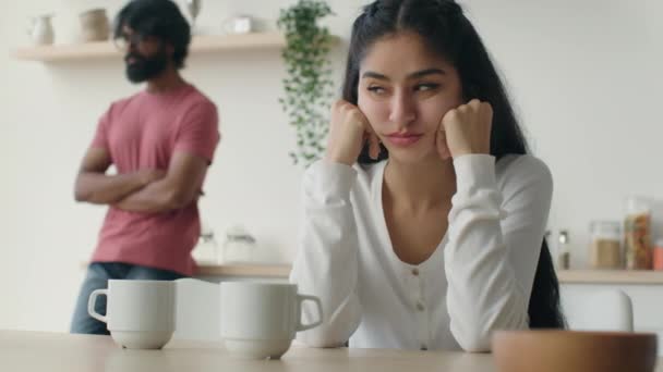 Stressed married couple in kitchen upset woman wife suffer after family quarrel conflict arabian offended man husband stand background psychological problem relationship breakup divorce abuse ignoring - Footage, Video