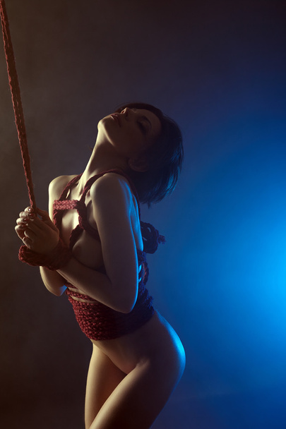 BDSM concept. Languid nude woman tied with rope - Photo, image