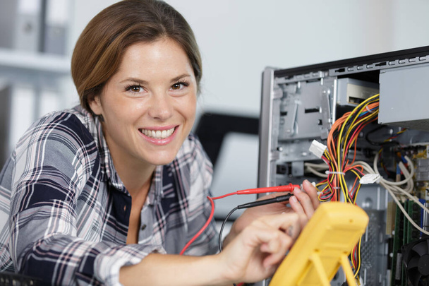 happy female technician repairing a computer - Valokuva, kuva