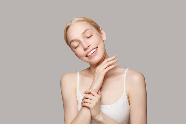 Skin care concept. Beautiful young healthy blonde woman with clear shiny skin relaxing and smiling, portrait.  - Φωτογραφία, εικόνα