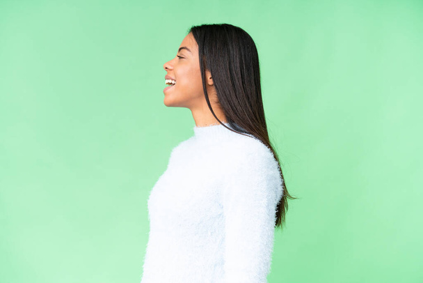 Young African American woman over isolated chroma key background laughing in lateral position - Foto, Imagem