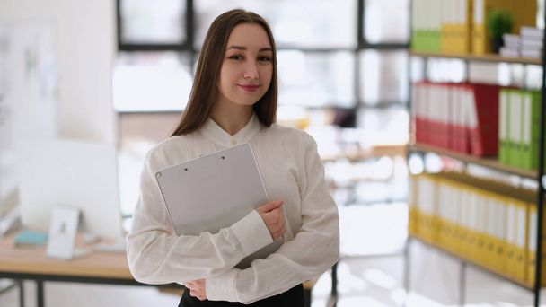 Portrait of successful businesswoman with documents in hands in office. Professional business consulting concept - Foto, Imagem