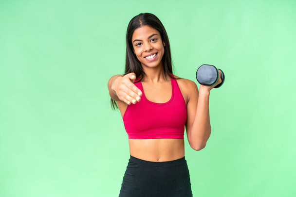 Young African American woman sport woman making weightlifting over isolated chroma key background shaking hands for closing a good deal - Photo, Image