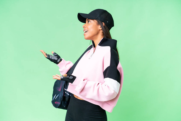 Young sport African American woman with sport bag over isolated chroma key background with surprise facial expression - Fotoğraf, Görsel
